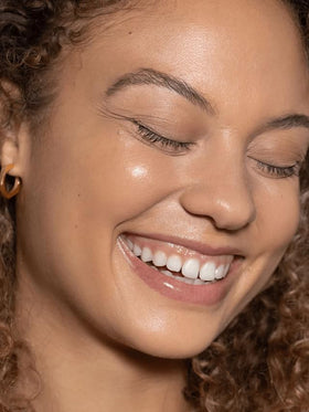 ILIA being blended with fingers for a natural, hydrating finish