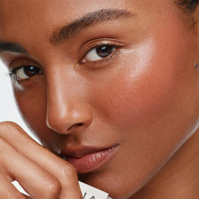 ILIA multi-stick applied on cheeks showing natural flushed look
