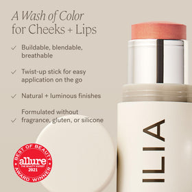 ILIA multi-stick next to everyday objects showing portable size