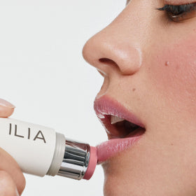 ILIA multi‑stick swatch on forearm showing buildable tenderly pink color payoff