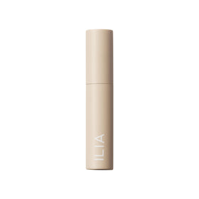 ILIA size comparison with coin illustrating compact 0.13 oz travel-friendly volume