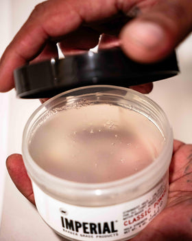 Imperial Barber Grade classic pomade being scooped onto hand, easy to spread and apply