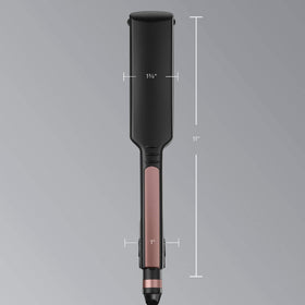 INFINITIPRO by Conair held in hand to show size and professional 1 3/4-inch plate scale