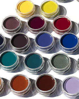 Inglot jar on a vanity next to brushes and cosmetics illustrating professional-ready application benefit