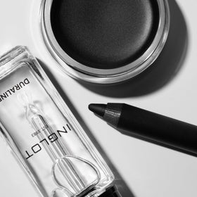 Inglot AMC gel eyeliner next to a coin for scale showing compact travel-friendly size