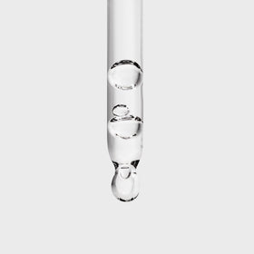 Inglot Duraline dropper detail releasing a clear drop for hygienic controlled application