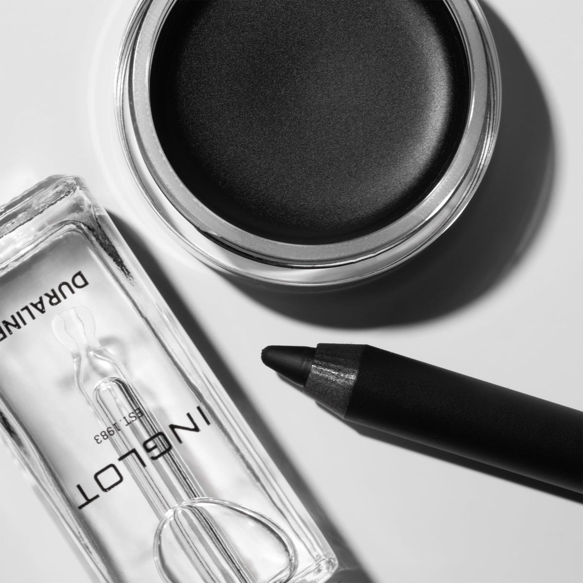 Inglot Duraline on a makeup station with powders and brushes for versatile creative looks