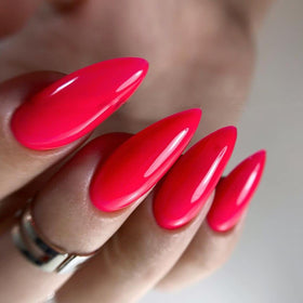 IN.HYPE finished manicure in neon pink #84 on hands showing vibrant salon-quality result