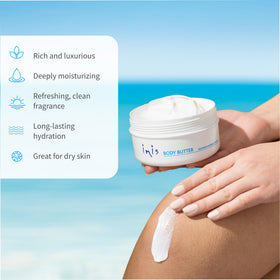 Hand applying Inis body butter to skin demonstrating smooth absorption benefit