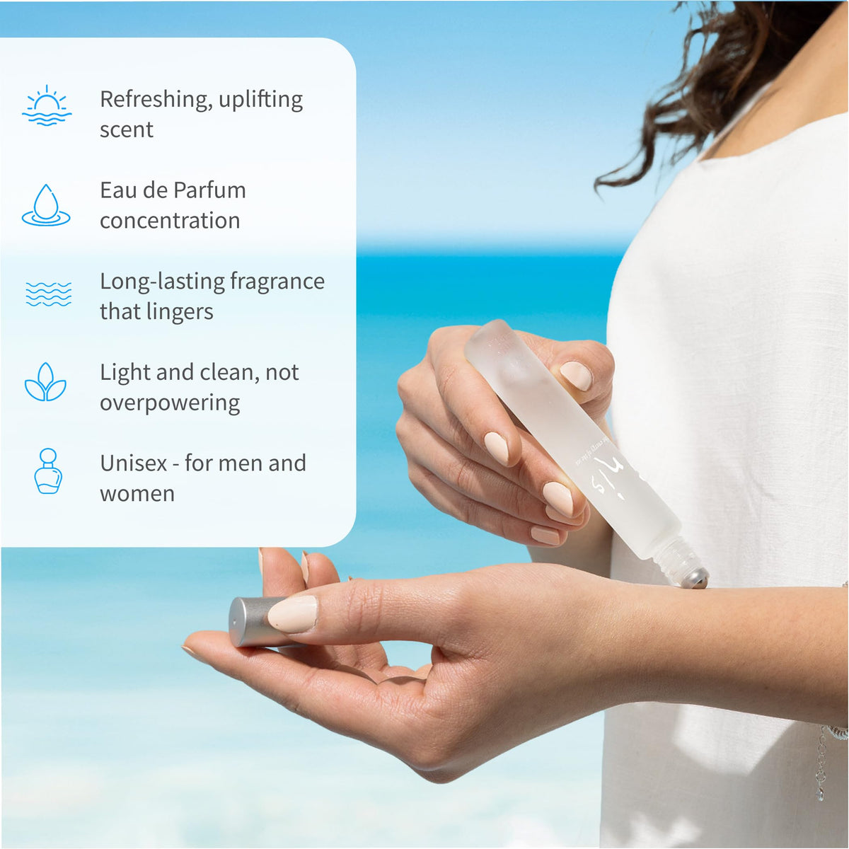 Hand holding Inis roll-on perfume to show travel-friendly compactness