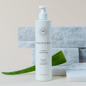 INNERSENSE conditioner applied to hand and hair demonstrating easy spread and soothing moisture