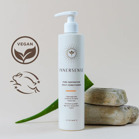 INNERSENSE conditioner in hand being applied to hair for detangling benefit