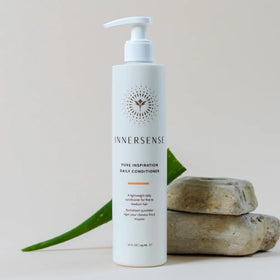 INNERSENSE bottles held in hand for size comparison, conveying travel-friendly 10 fl oz benefit