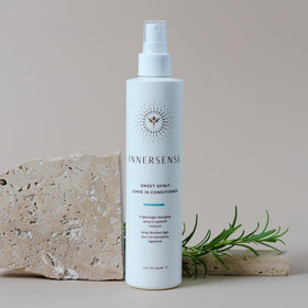 INNERSENSE bottle held in hand showing 10 fl oz scale and travel-friendly size
