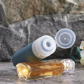 INSFIT close-up of 3 oz and 2 oz silicone bottles showing no-drip valve and squeezable design for controlled dispensing
