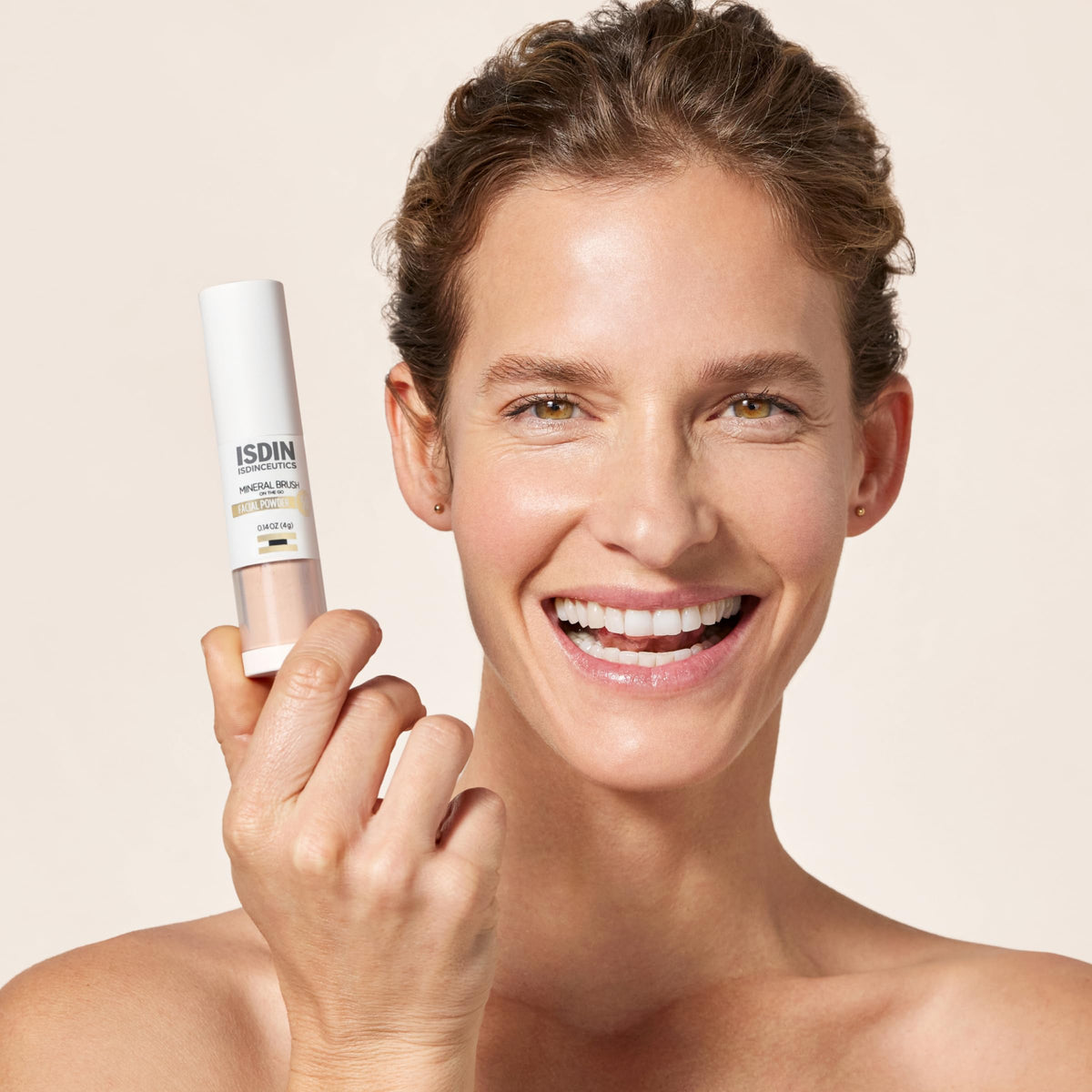ISDIN brush opened to reveal soft applicator demonstrating easy reapplication