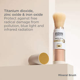 ISDIN brush held in hand illustrating compact travel-size benefit