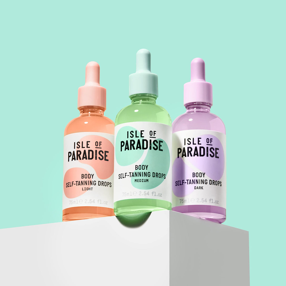 Isle of Paradise 2.54 fl oz bottle next to hand to show scale