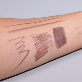IS'MINE lip pencils beside a purse to show compact travel-friendly size