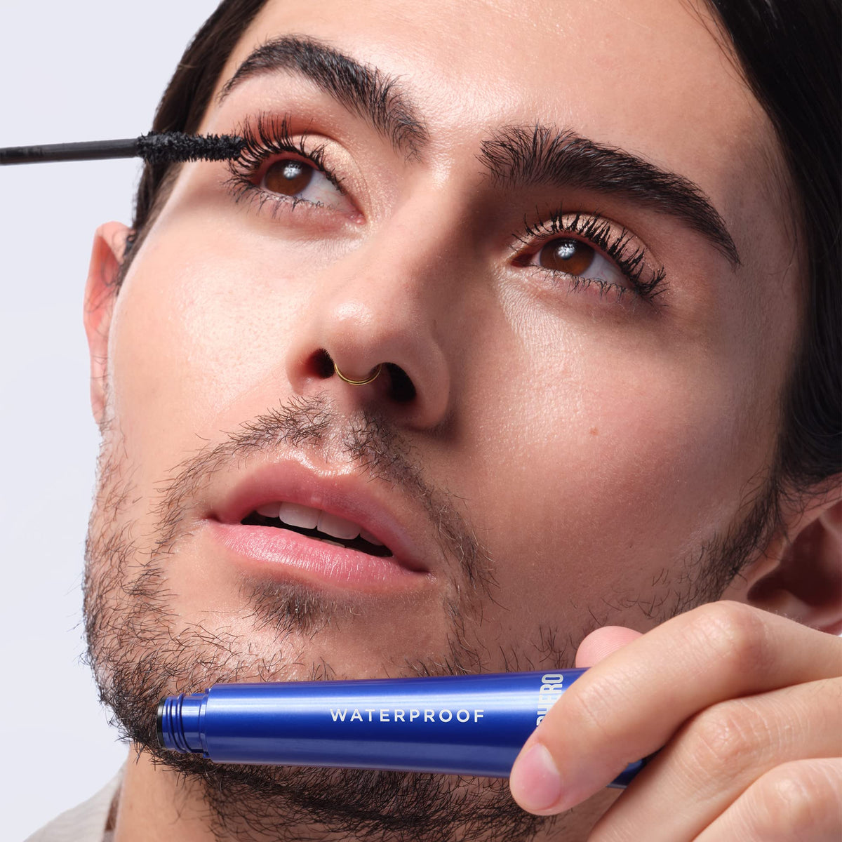 IT Cosmetics applying mascara in mirror for a lifestyle look and lasting wear benefit