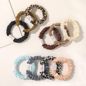 Ivyu scrunchie holding a neat bun, showcasing sleek low-bulk styling for events