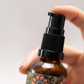 Turmeric and vetiver botanicals beside bottle with The Ayurveda Experience emphasizing nutrient boost