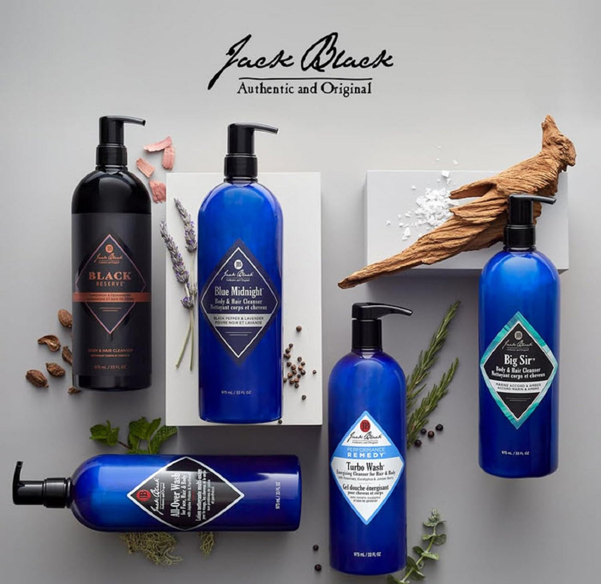 33 oz Jack Black bottle next to common toiletries, illustrates large travel-ready size
