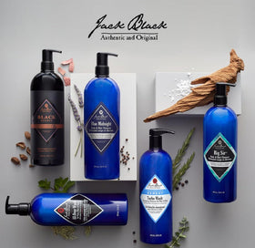 33 oz Jack Black bottle next to common toiletries, illustrates large travel-ready size