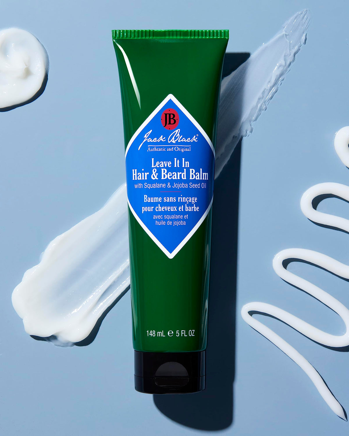 Jack Black applying balm to beard demonstrating tame frizz and softening benefit