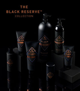 Jack Black bottle held in hand to show 33 fl oz scale and value size