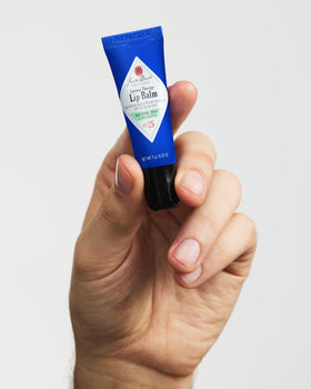 Jack Black tube in hand to show 0.25 oz scale and pocket-friendly convenience