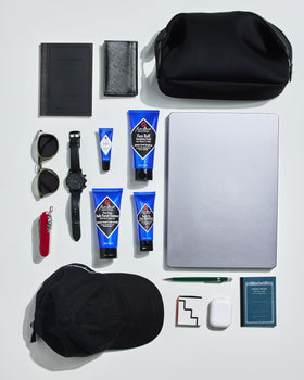 jack black kit next to passport showing TSA-friendly travel size convenience