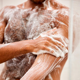 Jack Black texture lather on hand showing gentle cleansing foam for hair and body