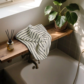 Jacquotha turban worn by woman in bathroom demonstrating comfortable anti-frizz hold