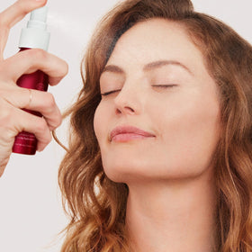 jane iredale bottle beside a ruler showing compact travel-friendly size