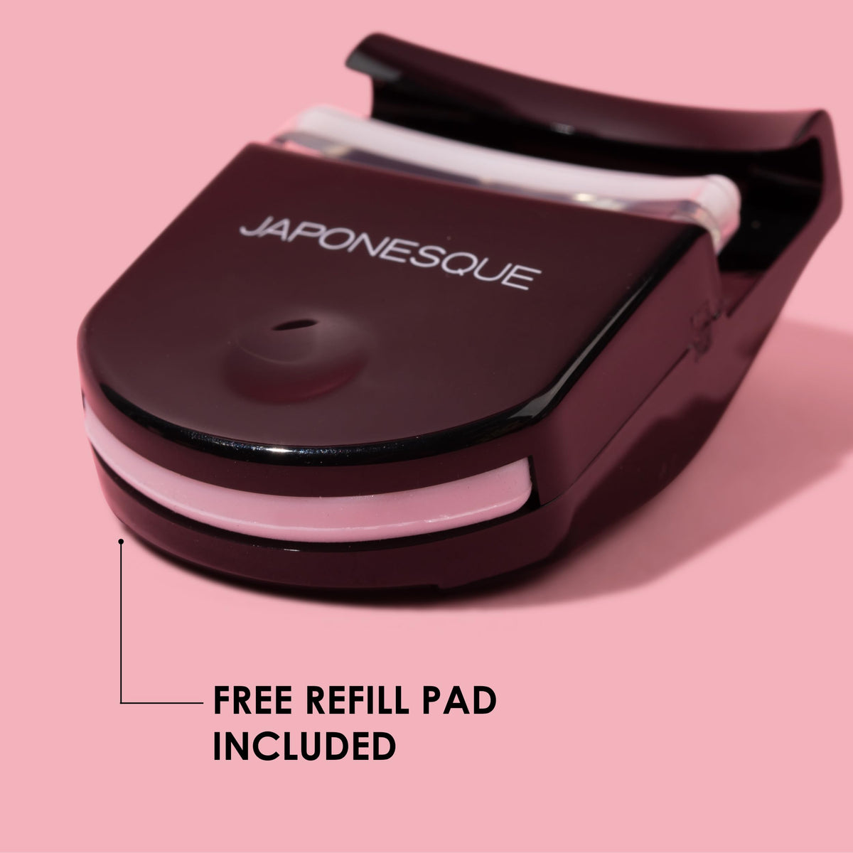 JAPONESQUE curler beside a makeup bag illustrating travel-ready convenience