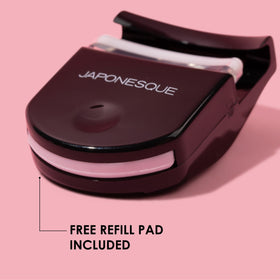 JAPONESQUE curler beside a makeup bag illustrating travel-ready convenience