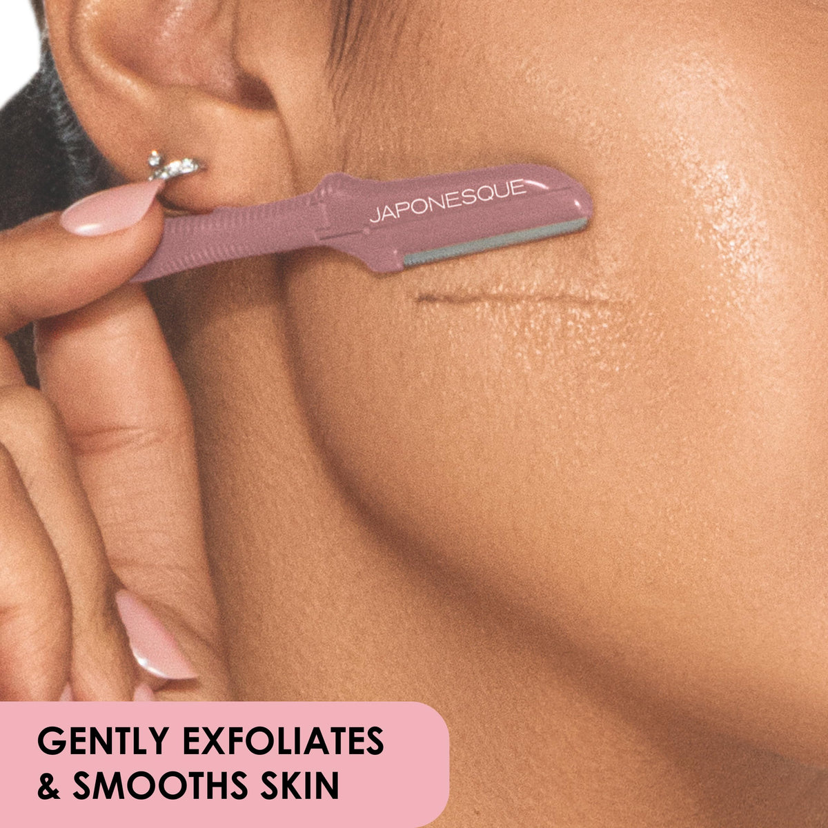 JAPONESQUE dermaplaner held in hand to show compact size and ergonomic control