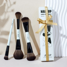 Jessup brushes held in hand to show compact travel-friendly size