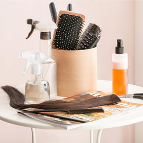 Jinei bottle misting a houseplant showing gentle even coverage benefit
