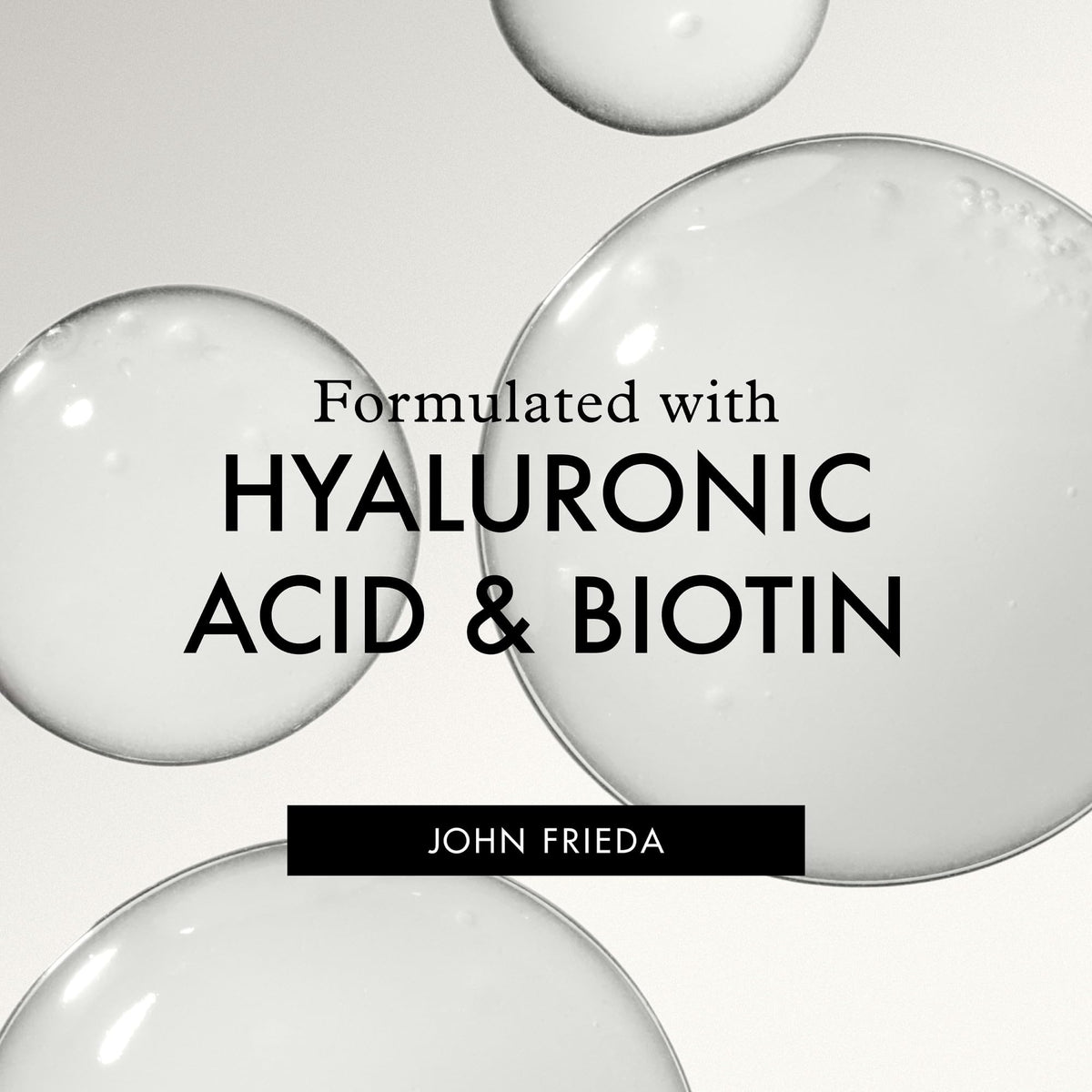 John Frieda label close-up focusing on ingredients like biotin and hyaluronic acid benefit
