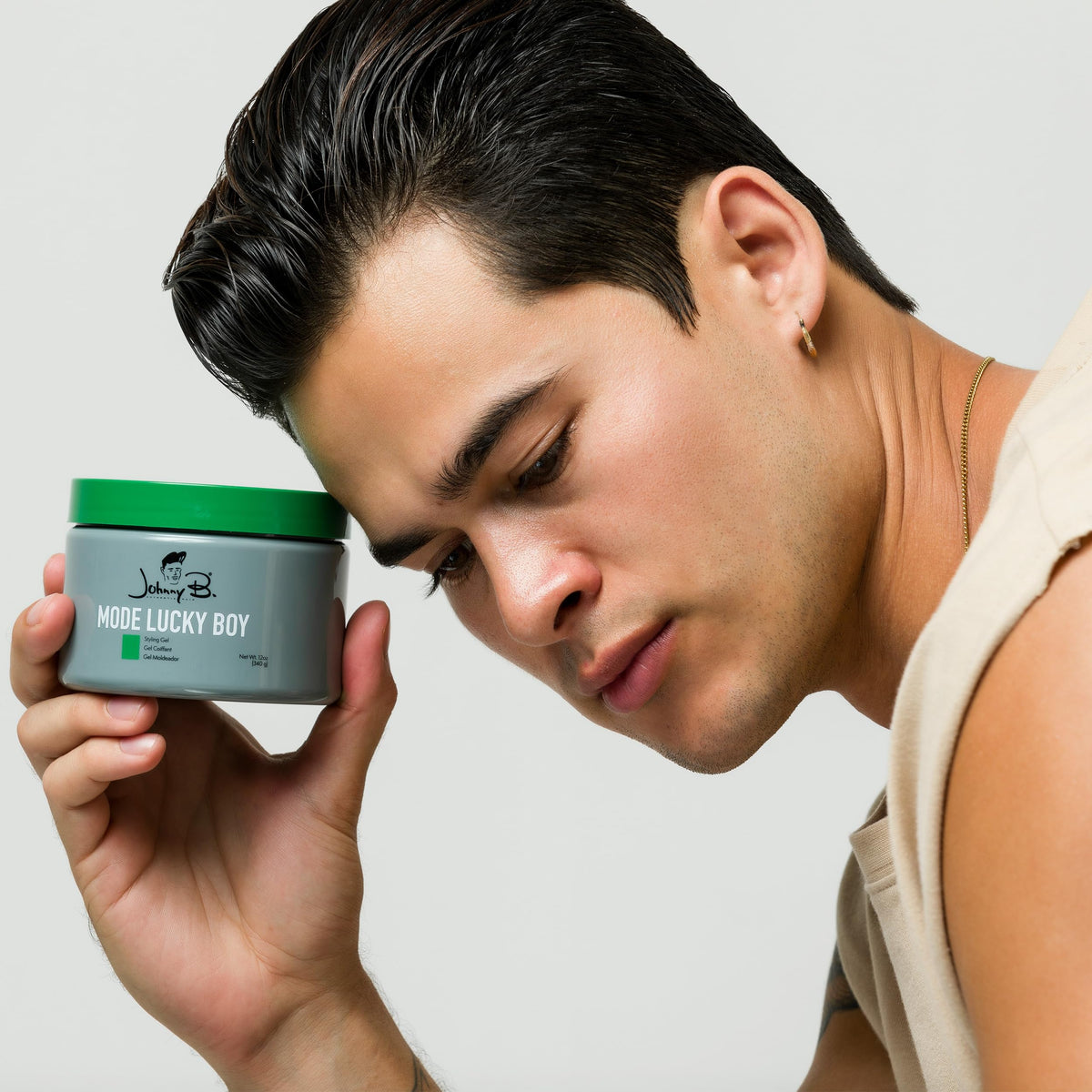 JOHNNY B. styling gel used on a groomed male hairstyle, shows defined shine and hold