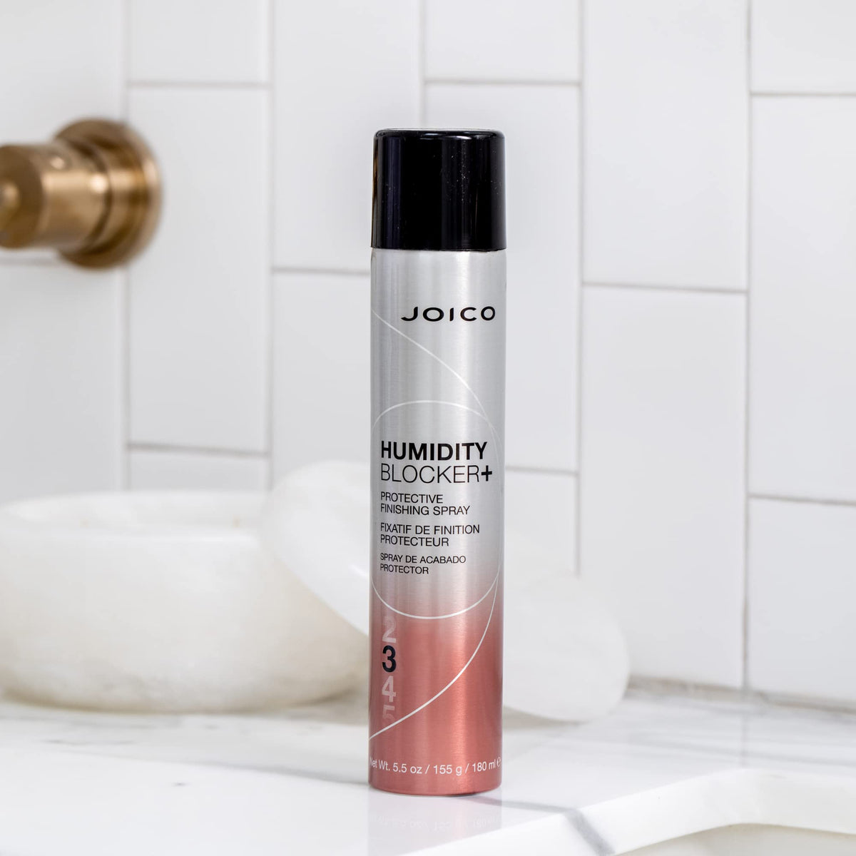 Joico product used on fresh blowout illustrating frizz reduction and hold benefit