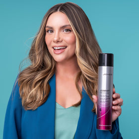 Hand holding 300mL Joico bottle for size and portability benefit