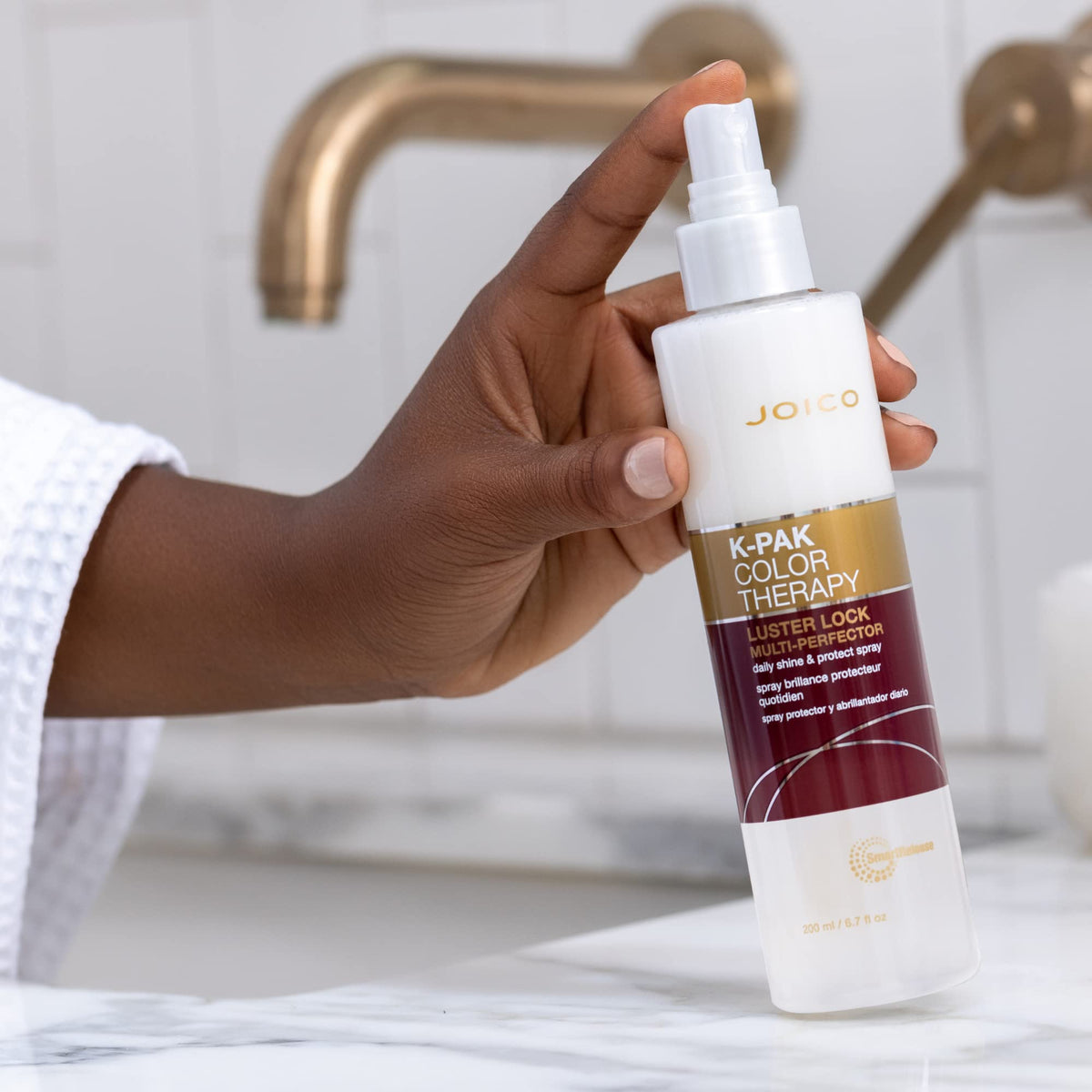 Joico bottle in hand to show travel-friendly 6.7 fl oz size