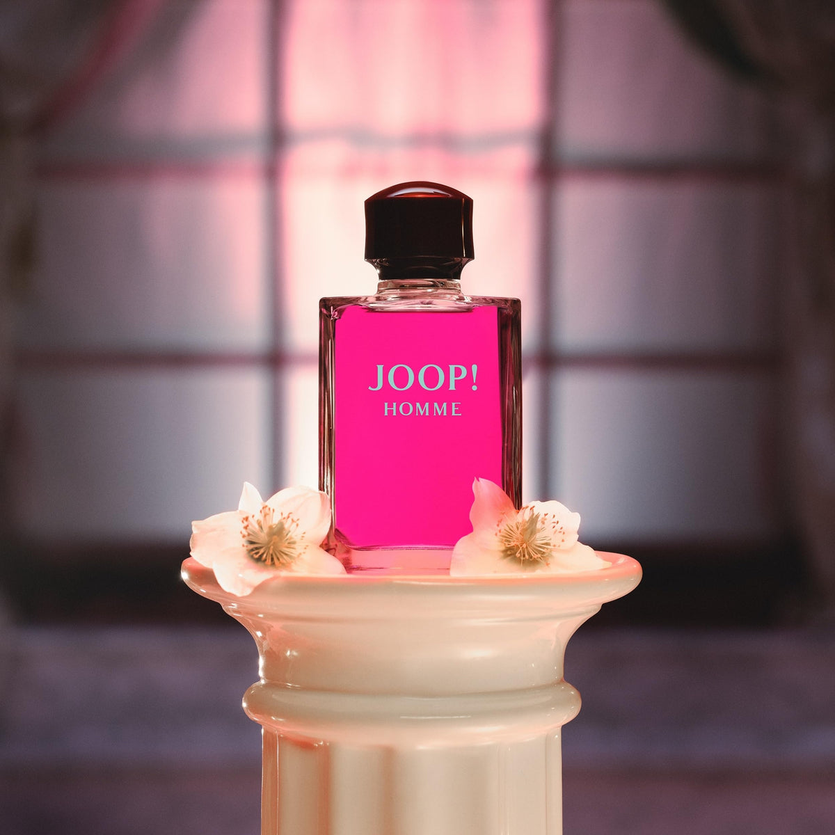 Joop! 1 fl oz bottle in hand indicating compact travel-friendly size and portability
