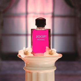 Joop! 1 fl oz bottle in hand indicating compact travel-friendly size and portability