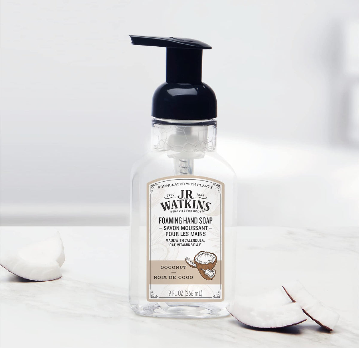 J.R. Watkins bottle next to sink for scale, demonstrating compact 9 fl oz convenience benefit