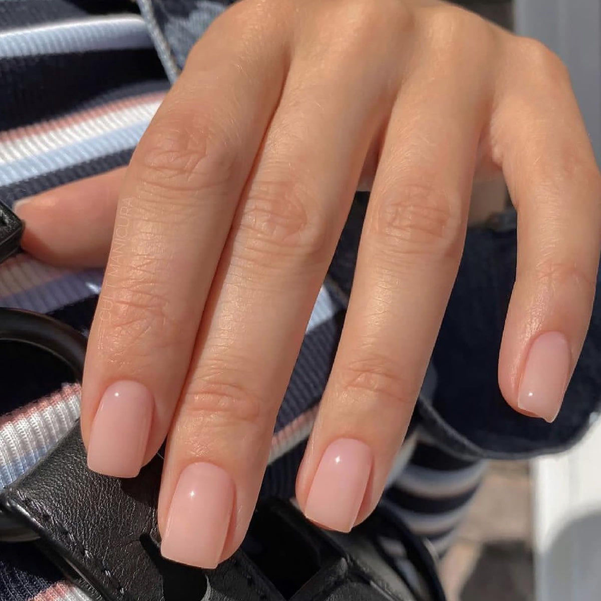 Jsiallye close-up of milky white French tip showcasing glossy finish