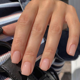 Jsiallye close-up of milky white French tip showcasing glossy finish